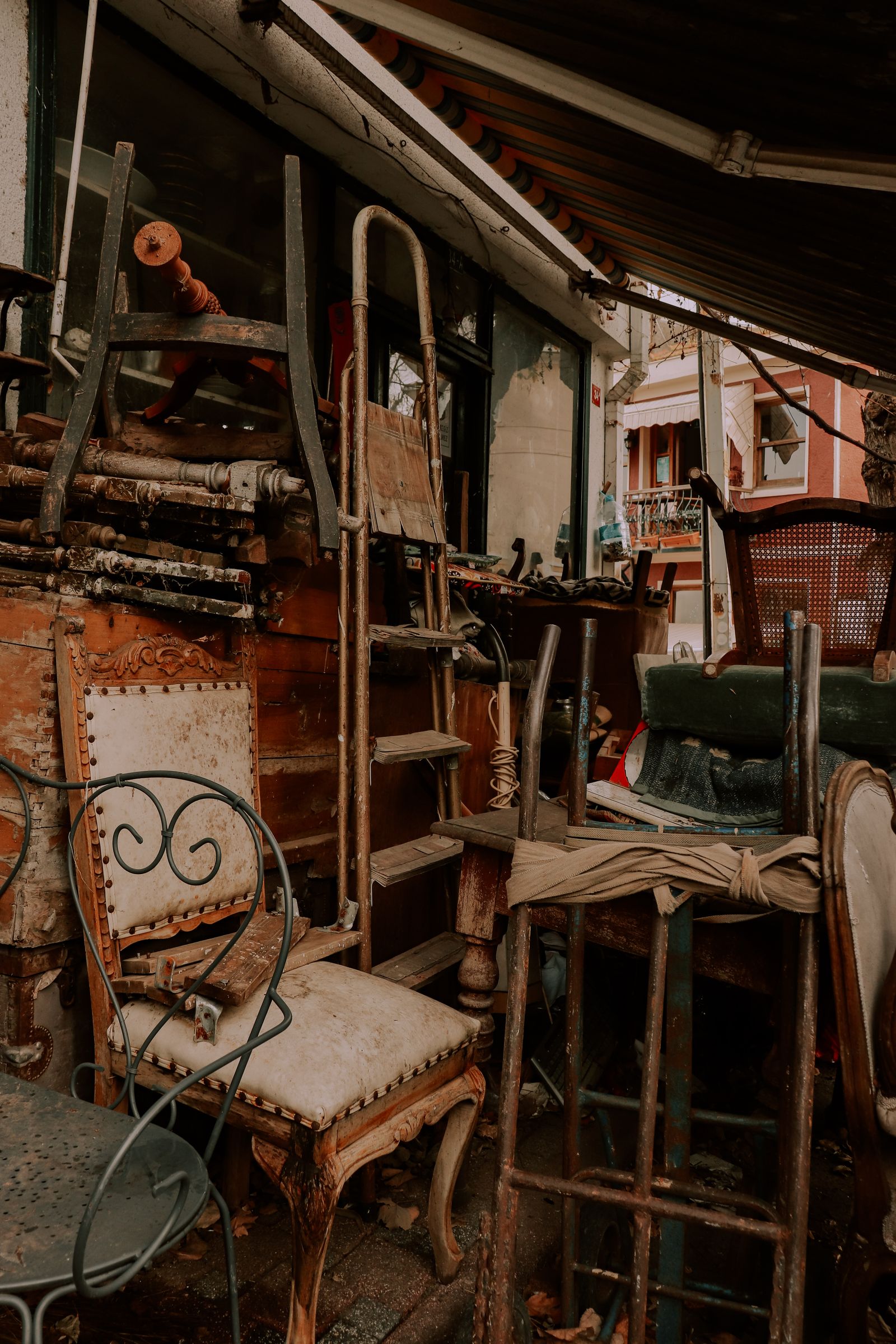 Stock photo of old furniture stacked outdoors. Not a DSNY photo. Not a New York City curb.
